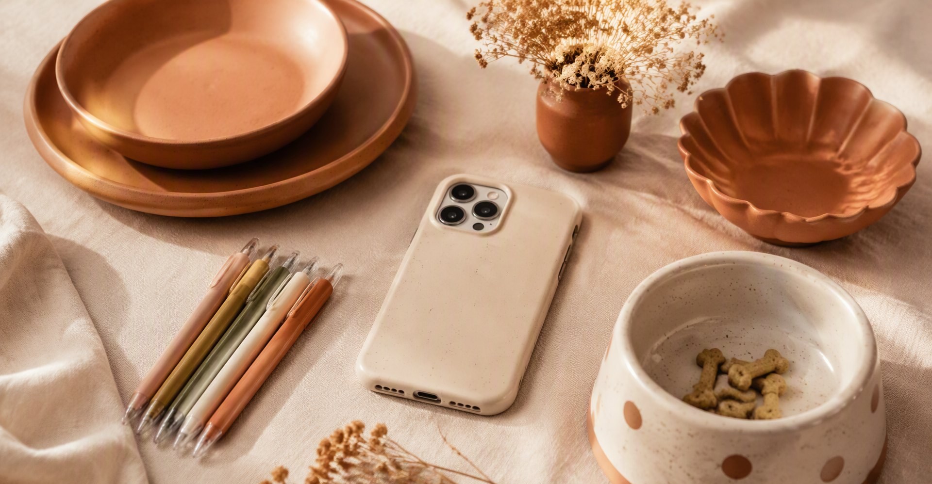 Warm lifestyle flat-lay of homeware, stationery and pet products
